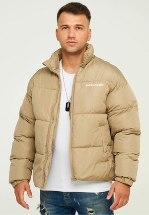 Beige puffer jacket with horizontal stitching, zip closure, and high collar. Features brand logo on the left chest and elastic cuffs.