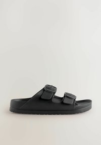 Sorte sandaler med to justerbare stropper og en struktureret overdel. Struktureret sål for greb, med et strømlinet, minimalistisk design.