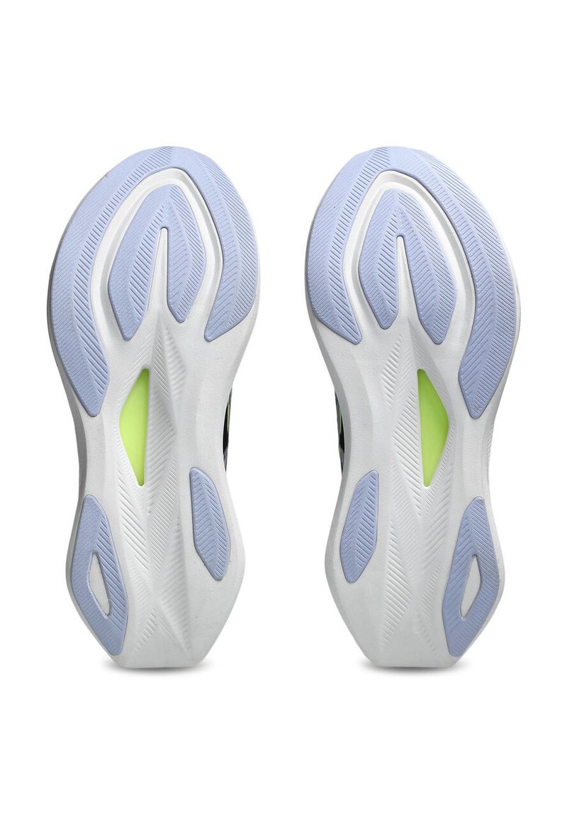 Shoe soles with a white base and light blue accents, featuring a textured pattern for grip, and a green accent in the midsole area.