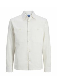 Chemise à manches longues en lin écru, dotée d'un col à boutons, de deux poches poitrine et d'une fermeture avant à boutons. Texture lisse.