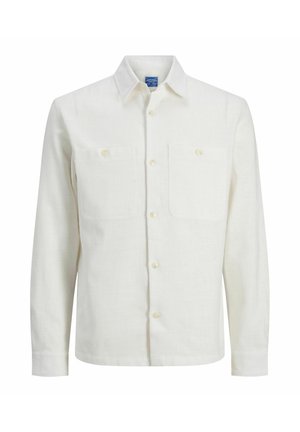 Chemise à manches longues en lin écru, dotée d'un col à boutons, de deux poches poitrine et d'une fermeture avant à boutons. Texture lisse.