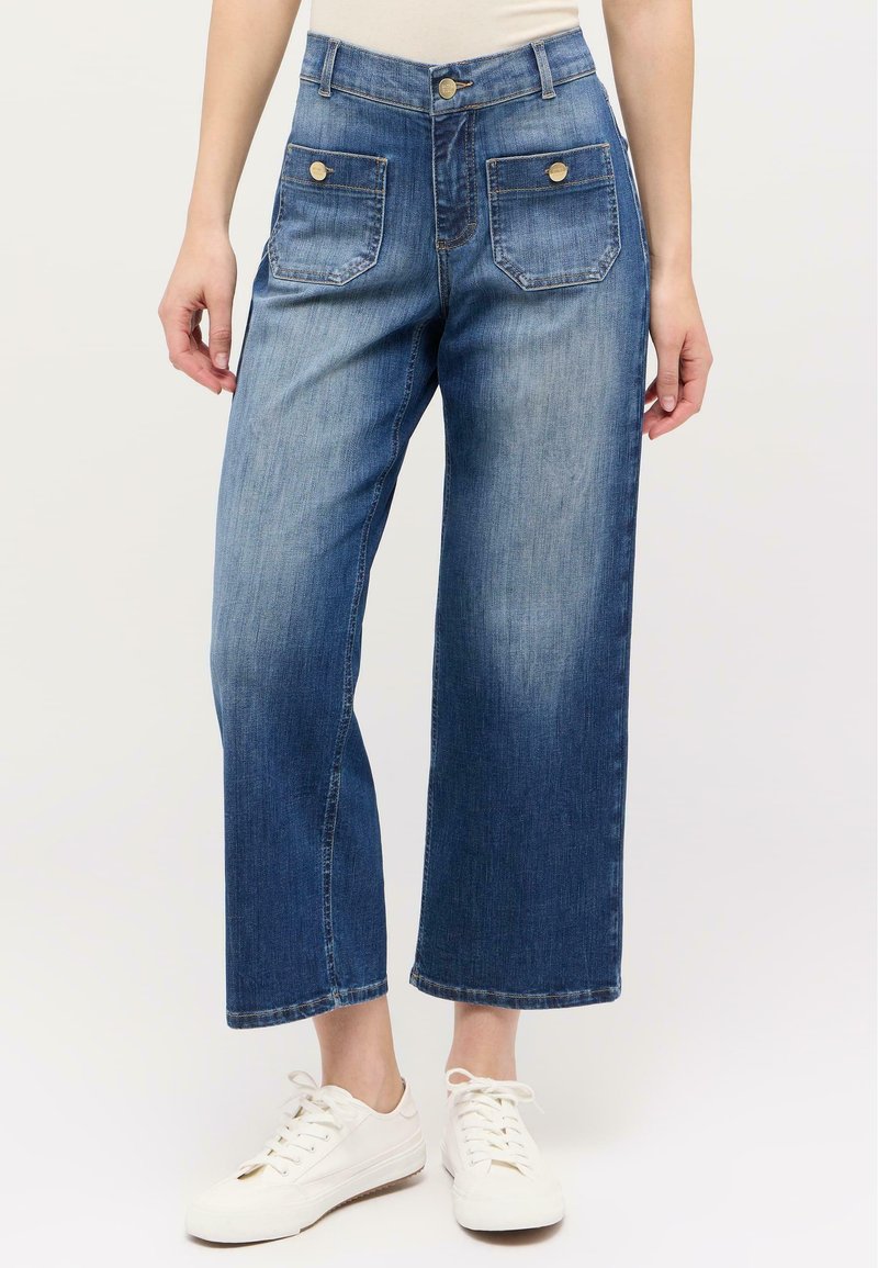 Jeans w modnym, wysokim stanem i szerokimi nogawkami w średnim niebieskim denimu, z dwiema przednimi kieszeniami oraz złotymi guzikami, o gładkiej fakturze.
