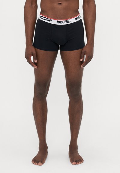 Black boxer briefs with a white and red Moschino logo waistband, form-fitting design, cotton material, and minimalistic shape.