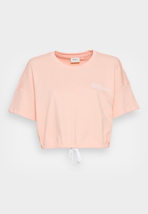 Rosa kortermet t-skjorte laget av myk bomull, med kortermede ermer og snøring i kanten. Inkluderer hvit tekst på fronten.
