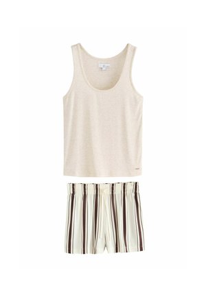 Woman with long dark hair wearing a light gray sleeveless tank top looking to the side against a plain background.