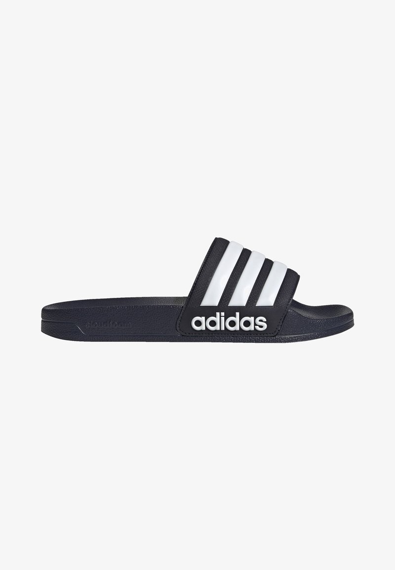 Black slide sandal with three white stripes and "adidas" logo. Made from soft material with a textured surface, featuring a contoured footbed.