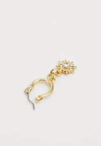 Gold-tone hoop earring featuring a sun-shaped charm with a central clear rhinestone, textured detailing, and a secure clasp mechanism.