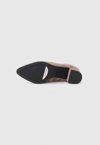 Pointed-toe, taupe suede pump with a low block heel, featuring a black rubber sole and metallic accent on the heel.