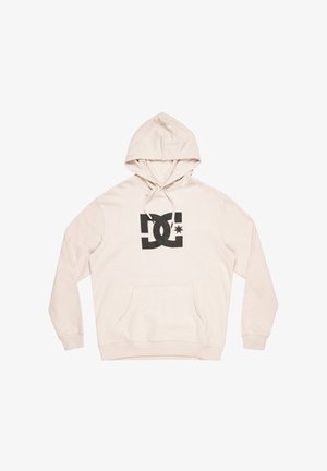 Cremefarbener Hoodie aus weichem Stoff mit einem schwarzen DC-Logo und einem Stern, Kängurutasche und Kapuze mit Kordelzug.