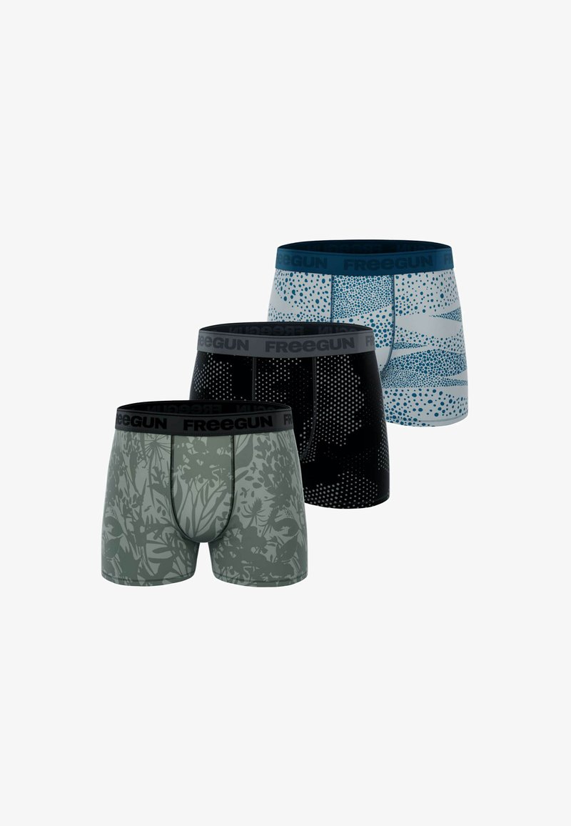 Trois paires de boxers pour hommes : gris avec un motif de feuilles, noir avec un motif à pois, et bleu/blanc avec un motif géométrique, dotés de ceintures élastiques.