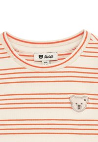 Gestreepte katoenen T-shirt met oranje en crèmekleurige strepen, een ronde halslijn en een berenlogo geborduurd op de borst.
