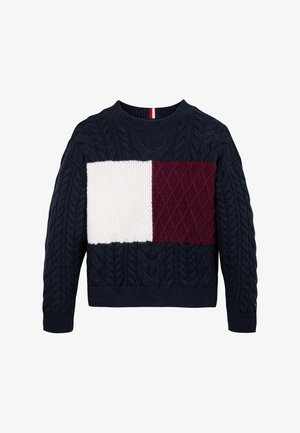 Pull en maille bleu marine avec texture en maille torsadée, comportant un panneau central crème et bordeaux avec des motifs contrastés. Encolure arrondie.