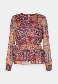 Blusa trasparente con maniche lunghe caratterizzata da un mosaico di motivi rossi, blu e crema. Polsini e vita elasticizzati per un effetto arricciato.