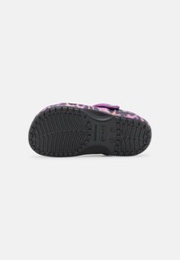 Crocs-style footwear with a textured purple and black printed upper, adjustable strap, and a patterned black rubber outsole for traction.
