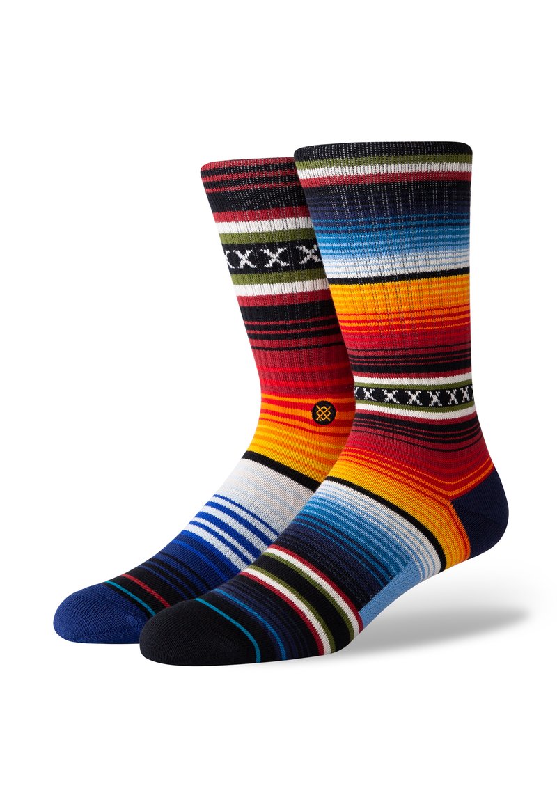 Multicolored socks featuring varied stripes in reds, blues, and yellows. Made of a soft knit with solid dark blue and black toes.