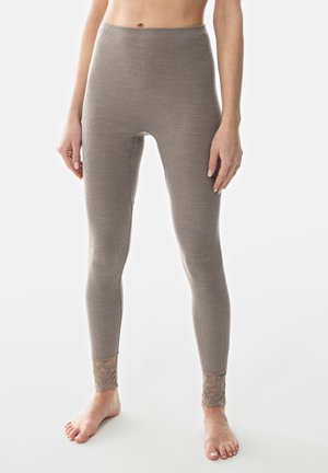 Leggings côtelés beiges avec taille haute, ornés de dentelle aux chevilles. Fabriqués à partir d'un matériau doux et extensible pour le confort.
