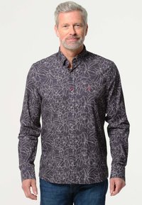 Heren donker bloemen overhemd met lichte grijze bloemmotieven, een gestructureerde kraag en contrasterende knopen. Gepaarde met casual denim broek.