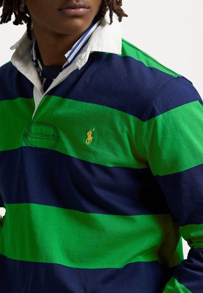 Green and navy striped rugby shirt with a white collar, featuring a small gold logo and textured fabric.