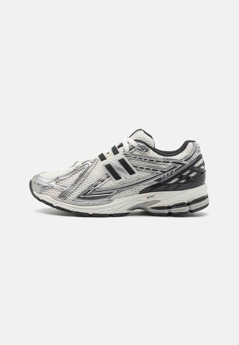 Men's running shoes in white mesh with black accents, featuring a cushioned sole, lace-up design, and a textured surface for grip.