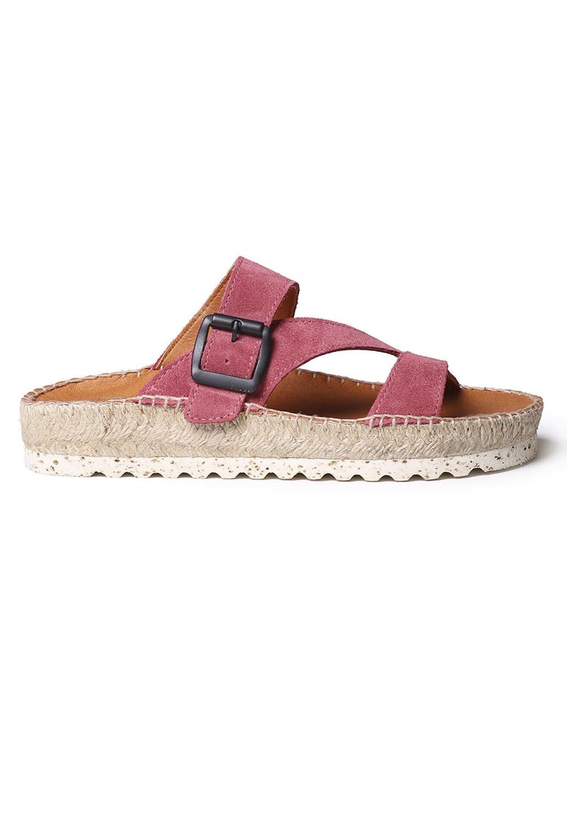 Pink suede slide sandal with crisscross straps, black buckle accent, jute-wrapped sole, and a textured footbed for comfort.