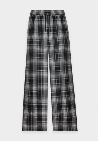 Pantalon large à carreaux noir et blanc avec taille élastique et cordon, présenté à plat sur un fond clair.