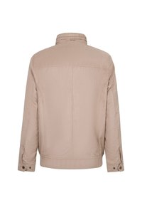 Beige jacket with a smooth texture, structured collar, and long sleeves featuring snap-button closures. Simple design and clean lines.