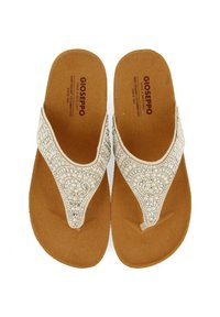 Des sandales thong blanches avec des bandoulières embellies de perles, une semelle en liège et un sol plat pour une tenue décontractée.