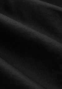 Tissu noir avec une texture lisse et mate, présentant de subtils plis et une surface homogène, adapté à diverses applications textiles.