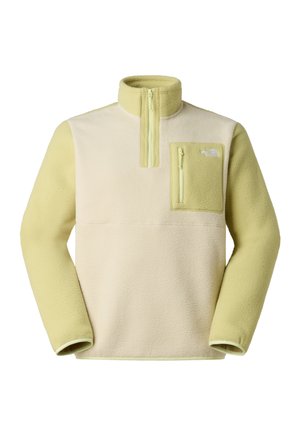 Sudadera de forro polar en crema y verde lima. Cuenta con un cuello con media cremallera, bolsillo en el pecho con cremallera y tela suave y texturizada.