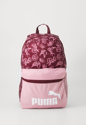 Maroon backpack with pink floral pattern, pink lower section, front pocket, and white Puma logo. Features adjustable straps and a top handle.