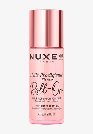 Roze NUXE Paris Huile Prodigieuse Florale Roll-On multifunctionele droge olie fles, 60 ml, met metalen roségouden dop.
