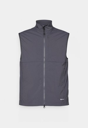 Gilet sans manches en tissu gris foncé, avec un col haut, une fermeture éclair à l'avant et une petite poche zippée sur la poitrine. Texture lisse.