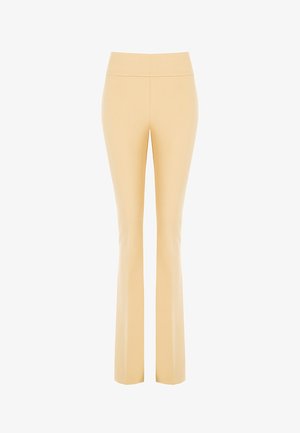 Hoge taille, uitlopende broeken in lichtgeel, gemaakt van rekbare stof. Gladde textuur zonder zichtbare patronen of hardwaredetails.