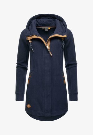 Navy fleece jacket with contrasting tan accents, a hood, zipper pockets, and a mid-length design. Features ribbed cuffs and a logo patch.