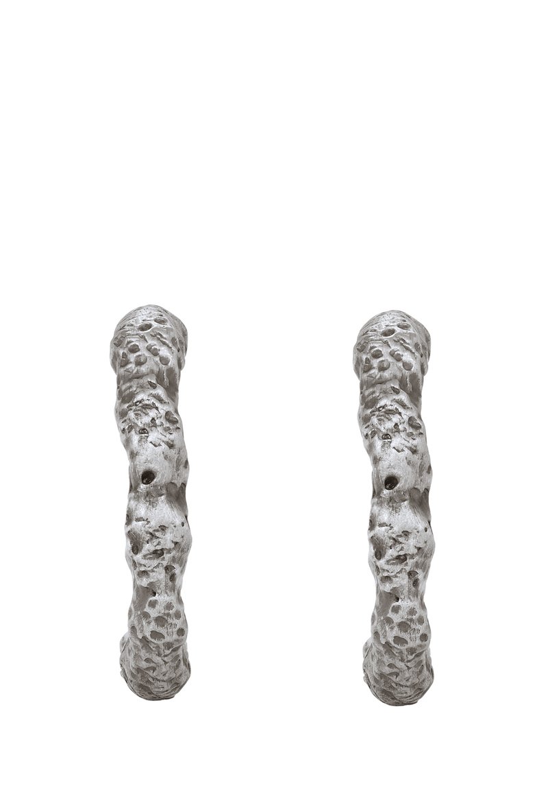 Texturerade metalörhängen med en organisk, oregelbunden form, en matt silverfinish och ytdetaljer av små indragningar.