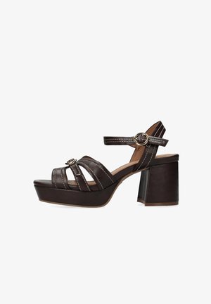Sandali con tacco marrone caratterizzati da un tacco spesso a blocco, cinturini orizzontali e un dettaglio con fibbia. Realizzati in materiale sintetico con cuciture bianche.