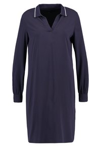 Marinblå klänning med långa ärmar, V-ringning och krage med vit kant. Mjuk väv och elastiska ärmslut för en avslappnad passform.