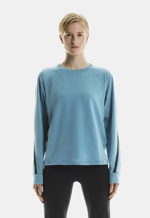 Light blue long-sleeve sweatshirt with raglan sleeves and thumbholes. Soft fabric with a smooth texture. Black accents on sleeves.