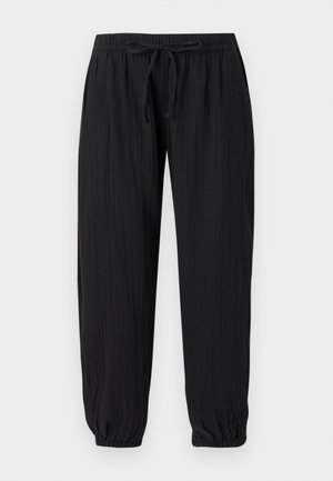 Pantalon noir léger avec taille élastique, fermeture à cordon de serrage et poignets élastiques aux chevilles.