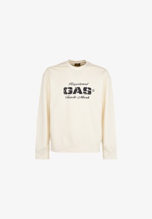 Crèmekleurige sweatshirt met lange mouwen en zwarte verweerde tekst "Registered GAS Trade Mark" gecentreerd aan de voorkant.