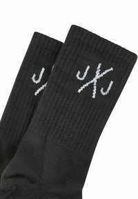 Black socks with ribbed texture and white brand logo. Features a classic crew length design suitable for casual wear.