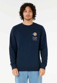 Navy blue sweatshirt with long sleeves, ribbed cuffs, and hem. Features a yellow and blue graphic print of palm trees and text on the chest.