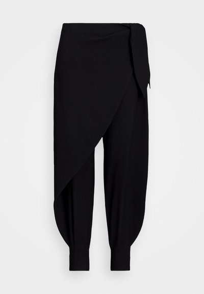 Zwarte, lichte broek met een gedrapeerd ontwerp, asymmetrische tailleband en taps toelopende enkelmanchetten. Gladde textuur en minimale details.