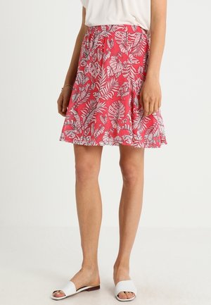 Jupe imprimée florale en rose avec des feuilles tropicales blanches, dotée d'une taille élastique et d'une silhouette évasée. Tissu léger et décontracté.