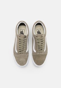 Bruna mockaskinns- och mesh-sneakers med vita sidodetaljer, rund tå och platta snören. Har textilerad yta och en logotyp på inläggssulan.