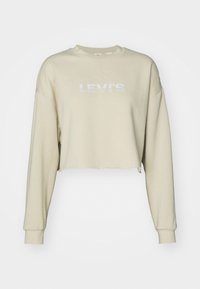 Sweat-shirt court beige à manches longues avec poignets côtelés et logo "LEVI'S" blanc sur le devant.