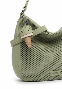 Green perforated leather handbag with a curved shape, featuring a detachable ice cream charm. Includes a flat strap and a logo tag.