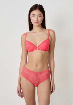 Coral lace lingerie set featuring a bralette with adjustable straps and a floral pattern, paired with high-waisted lace briefs.