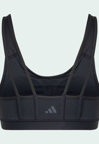 Sujetador deportivo negro con tirantes finos, fabricado en material elástico. Presenta un diseño sólido y un logo reflectante en la parte delantera.