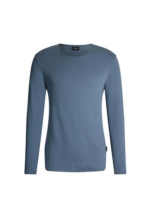 Chemise à manches longues en coton bleu doux avec un col rond, des détails de couture minimaux et une coupe décontractée.